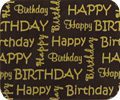 A HAPPY BIRTHDAY GOLD coaster with gold letters on a brown background.