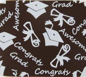 A GRADUATION WHITE 10" X 11" coaster with graduation hats on it.