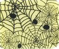 A SPIDER WEB with black spiders on a yellow background.