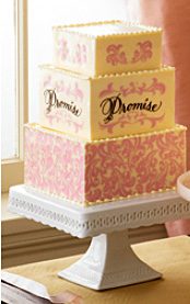 716 A pink and white cake with the word promise on it.