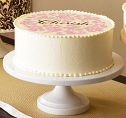 719 A pink and white cake with the word 'love' on it.