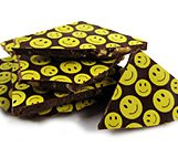 A pile of chocolate bars with smiley faces on them.