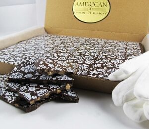 JACOBEAN - Chocolate Toffee Bark Slab Gift 16 oz in a box next to pair of gloves.