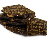 A pile of chocolate bars with happy birthday written on them.