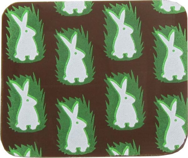 A brown coaster with white rabbits on it.