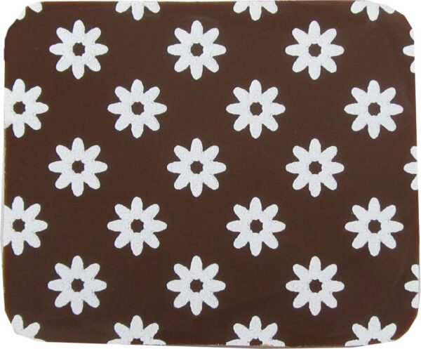 A brown and white coaster with daisies on it.