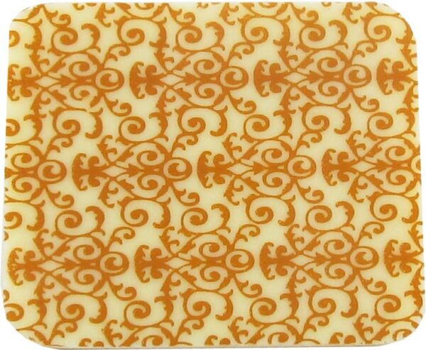 An orange and white coaster with a floral pattern.