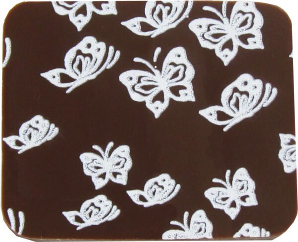 A white and brown coaster with butterflies on it.