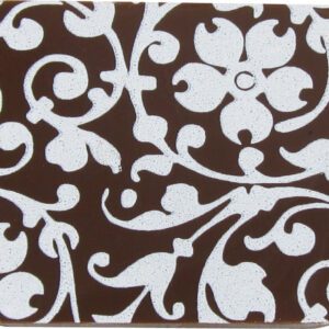A brown and white coaster with a floral design.