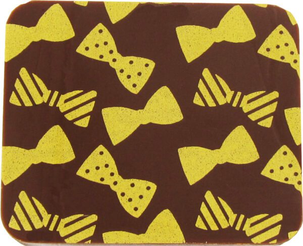 A brown and yellow coaster with bow ties on it.