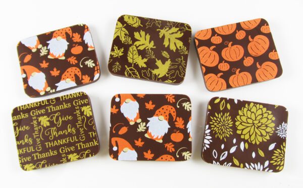 A set of coasters with autumn leaves and gnomes.