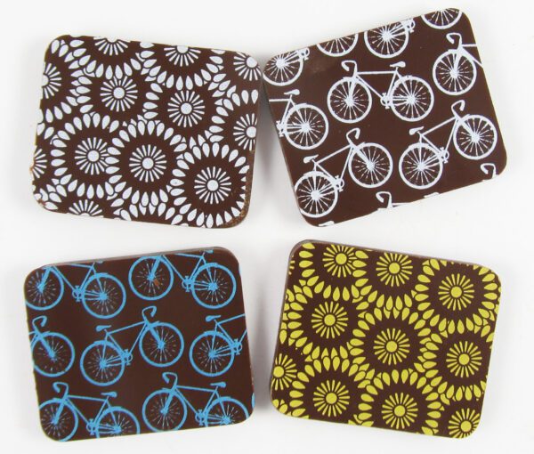 Four coasters with bicycle designs on them.