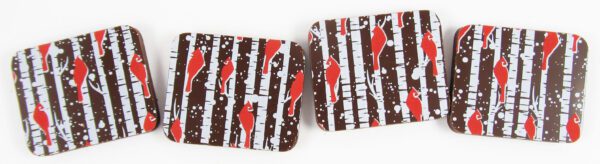 Four chocolate bars with red and white stripes on them.