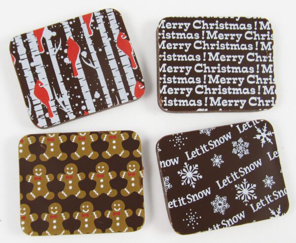 Four coasters with christmas designs on them.