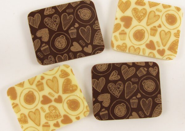 Three chocolate coasters with hearts on them.