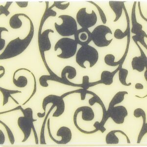 A black and white coaster with a floral design.
