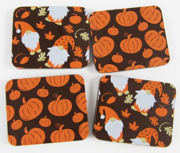 Four coasters with pumpkins and gnomes on them.