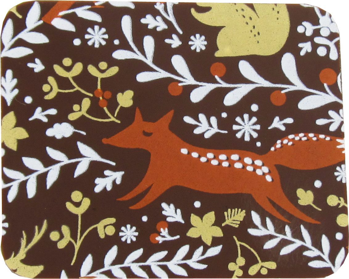 A brown coaster with foxes and flowers on it.