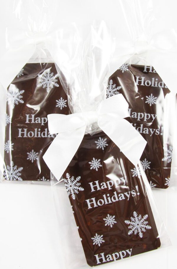 Three chocolate bars with happy holidays written on them.