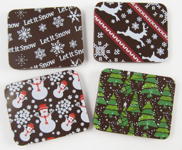 Four coasters with snowmen and snowflakes on them.