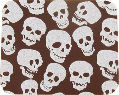 A brown coaster with white skulls on it.