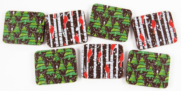 A group of chocolates with christmas trees on them.