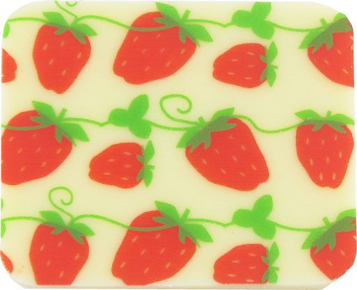 A strawberry shaped coaster with green and white stripes.