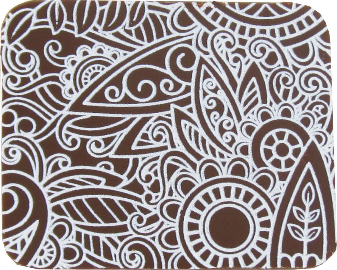 A brown and white coaster with a paisley design.