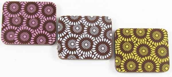 A set of three brown, Sunflower Yellow, and green patterned chocolates.