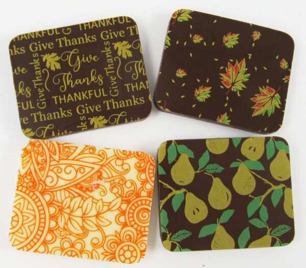 Four coasters with thanksgiving designs on them.